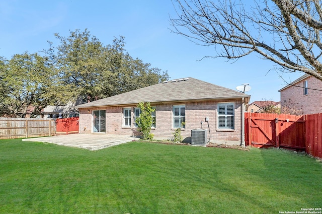 back of property with central AC, a patio, and a lawn