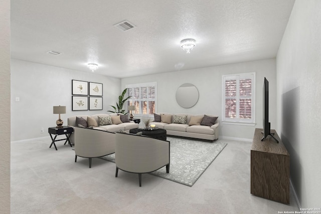 living room featuring light carpet and a textured ceiling