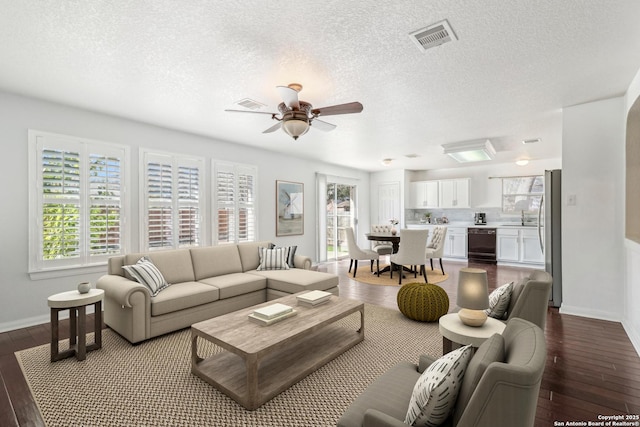 living room with sink, hardwood / wood-style floors, a textured ceiling, and ceiling fan