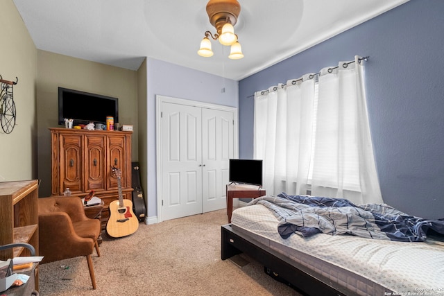 carpeted bedroom featuring ceiling fan and a closet