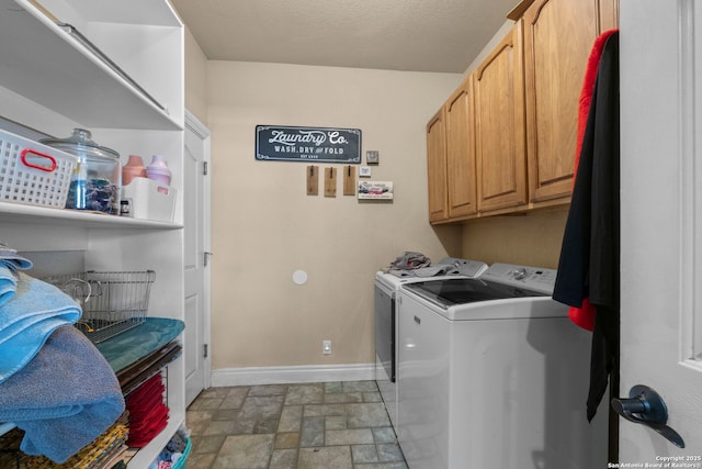 laundry area featuring separate washer and dryer and cabinets