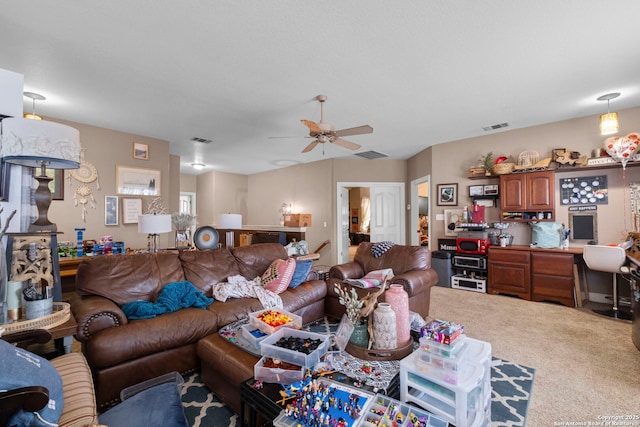 living room with ceiling fan and carpet