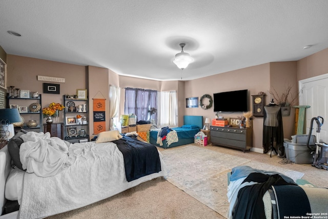 living room featuring ceiling fan, light carpet, and a textured ceiling