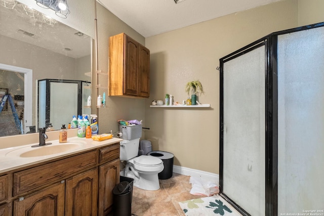 bathroom featuring tile patterned floors, vanity, toilet, and a shower with shower door