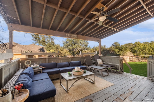 wooden terrace featuring an outdoor living space and ceiling fan