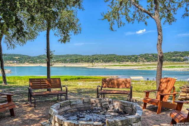 view of patio / terrace featuring a water view and an outdoor fire pit