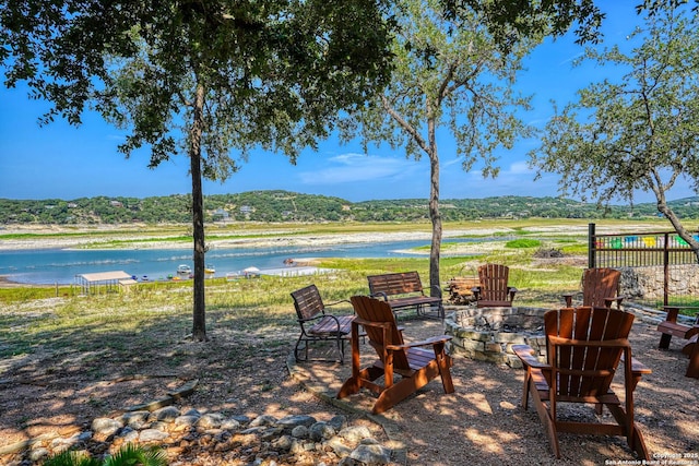 view of patio / terrace with an outdoor fire pit and a water and mountain view