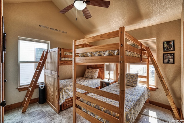 bedroom featuring lofted ceiling, a textured ceiling, and ceiling fan