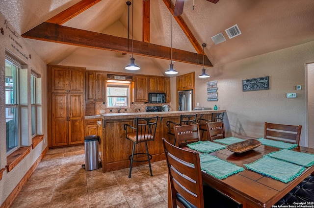 dining space featuring ceiling fan, lofted ceiling with beams, and a textured ceiling