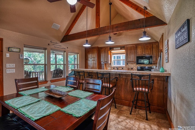 dining area with beam ceiling, high vaulted ceiling, and ceiling fan