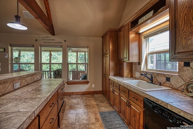 kitchen featuring sink, vaulted ceiling with beams, tile countertops, hanging light fixtures, and black dishwasher