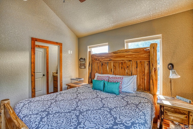 bedroom with vaulted ceiling and a textured ceiling