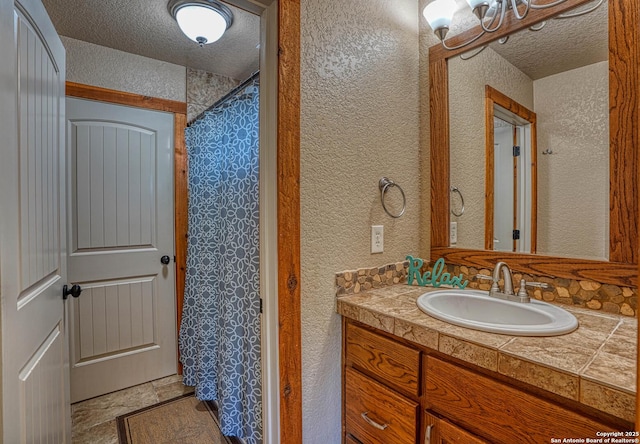 bathroom featuring vanity and a textured ceiling