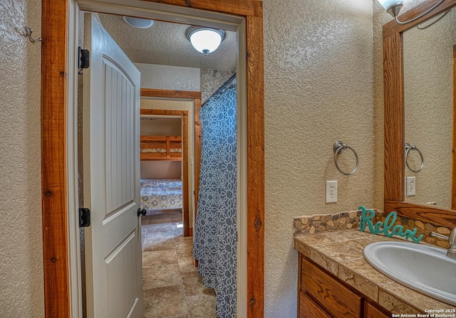 bathroom featuring vanity and a textured ceiling