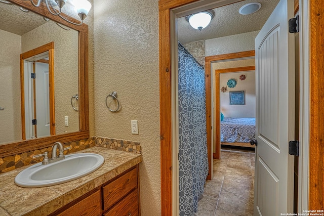 bathroom featuring vanity and a textured ceiling