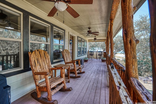 deck with ceiling fan and covered porch