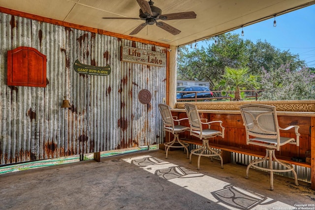 view of patio / terrace featuring a bar and ceiling fan