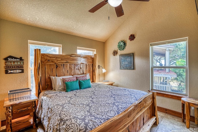 bedroom featuring lofted ceiling, light tile patterned floors, a textured ceiling, and ceiling fan