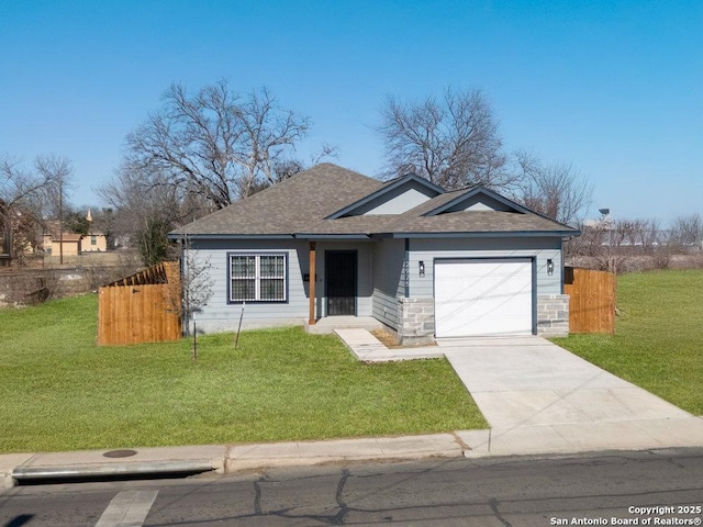 ranch-style home featuring a garage and a front lawn