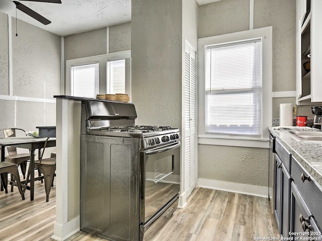 kitchen with ceiling fan, light hardwood / wood-style floors, and black range with gas cooktop