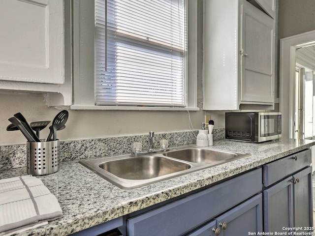 kitchen featuring sink and gray cabinets