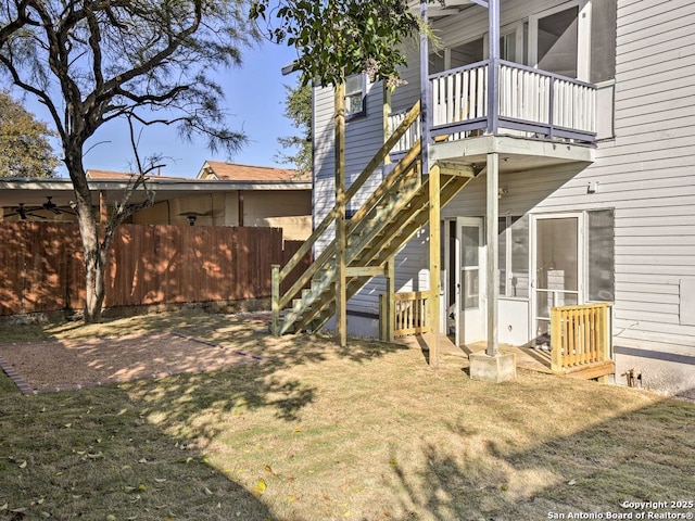 rear view of property with a sunroom and a yard