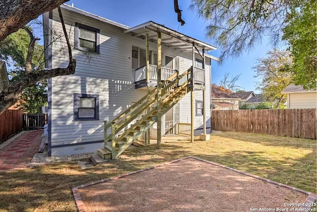 rear view of house with a yard