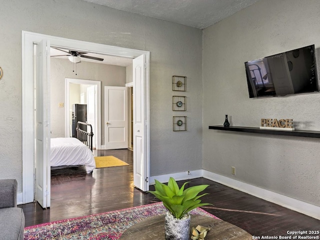 bedroom with ceiling fan and dark hardwood / wood-style flooring