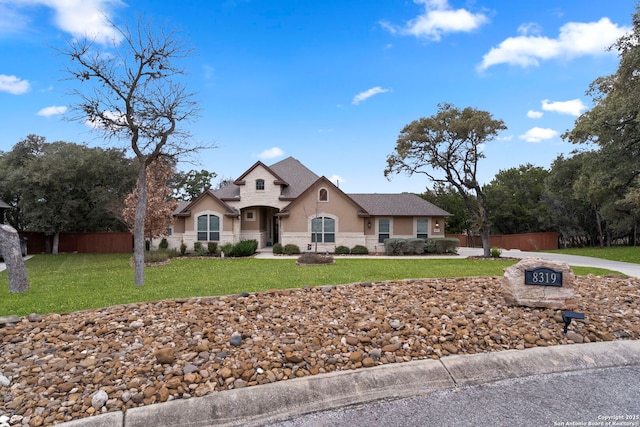 view of front of house featuring a front lawn and an outdoor fire pit