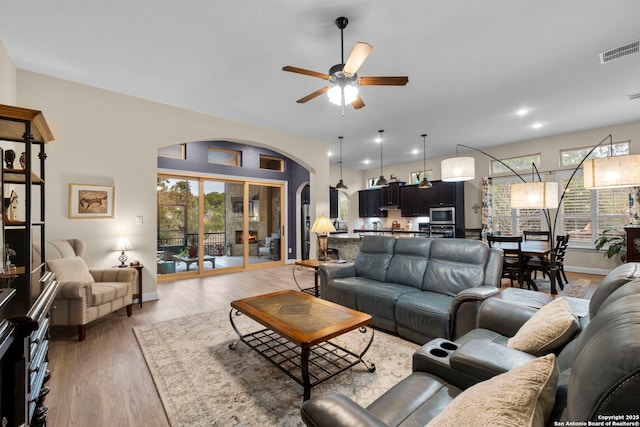 living room with hardwood / wood-style floors and ceiling fan