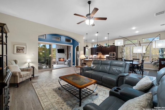 living room with ceiling fan and hardwood / wood-style floors