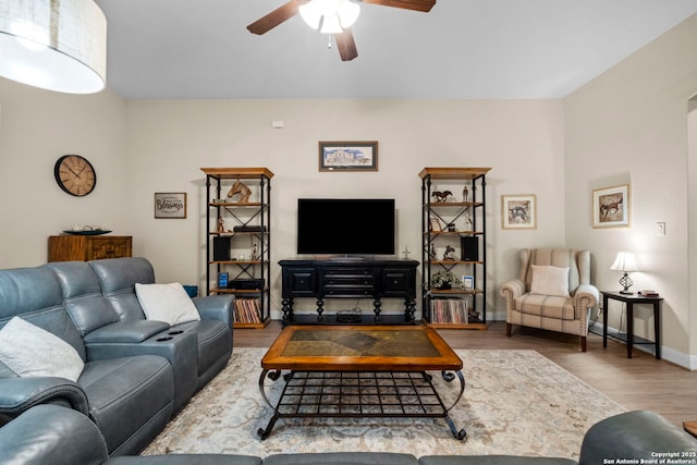 living room with wood-type flooring and ceiling fan