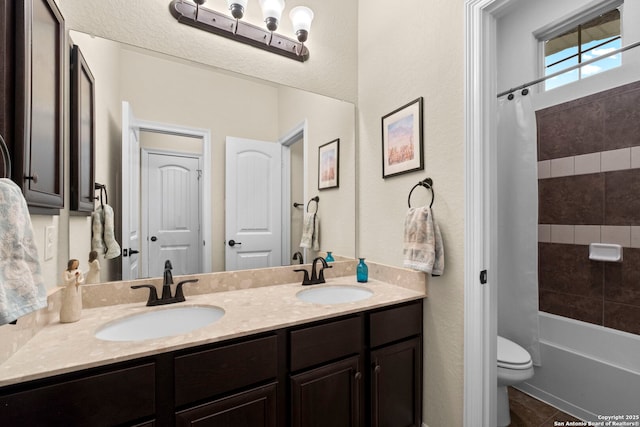 full bathroom with tiled shower / bath, vanity, toilet, and tile patterned floors