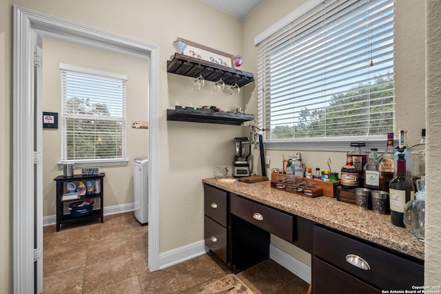 interior space featuring vanity, a wealth of natural light, and independent washer and dryer