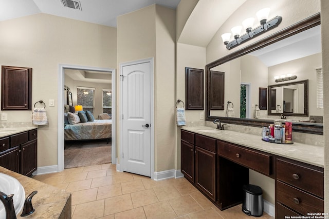 bathroom featuring lofted ceiling, tile patterned floors, and vanity