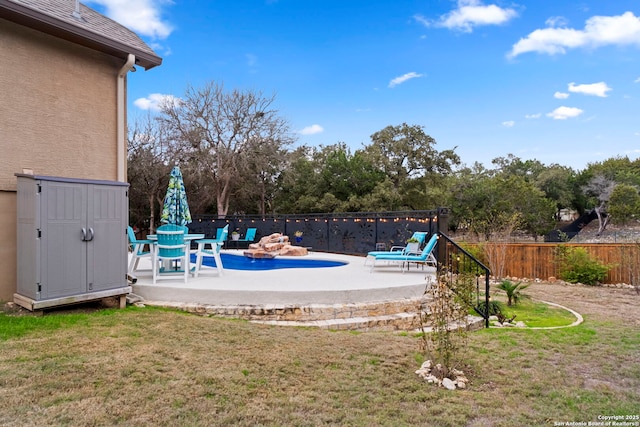 view of pool featuring a patio area and a lawn