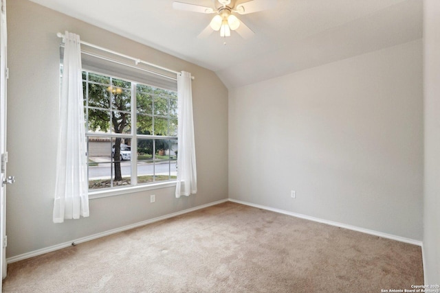 unfurnished room featuring carpet floors, ceiling fan, vaulted ceiling, and a healthy amount of sunlight