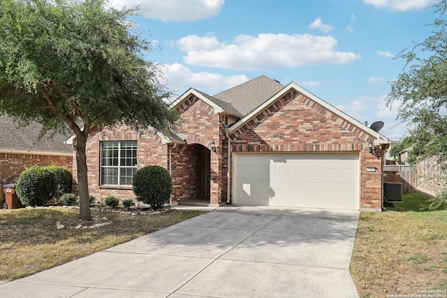 front of property featuring a garage, central AC unit, and a front lawn