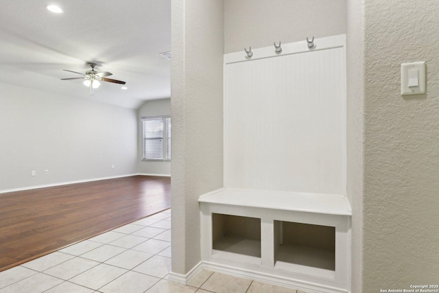 mudroom with lofted ceiling, light tile patterned floors, and ceiling fan