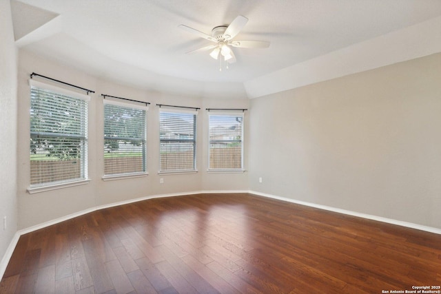 spare room with lofted ceiling, dark wood-type flooring, and ceiling fan