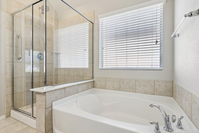 bathroom with independent shower and bath and tile patterned flooring