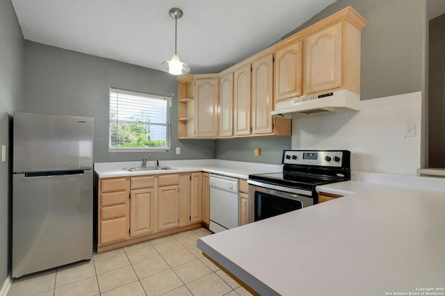 kitchen with stainless steel appliances, light brown cabinetry, sink, and hanging light fixtures