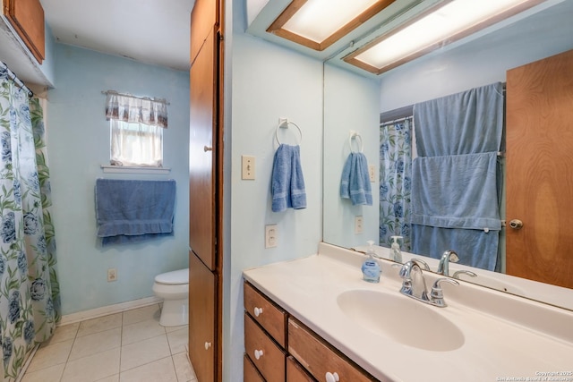 bathroom featuring vanity, tile patterned floors, and toilet