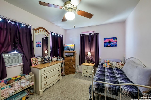 bedroom with light carpet, cooling unit, and ceiling fan