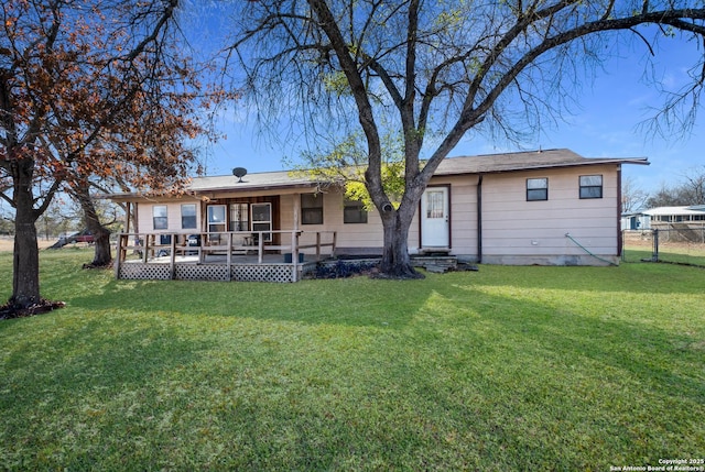 rear view of house with a yard and a deck