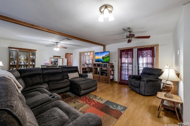 living room featuring hardwood / wood-style floors and ceiling fan