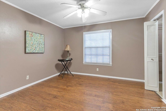 spare room featuring crown molding, hardwood / wood-style floors, and ceiling fan