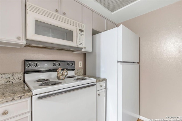 kitchen featuring white cabinetry and white appliances