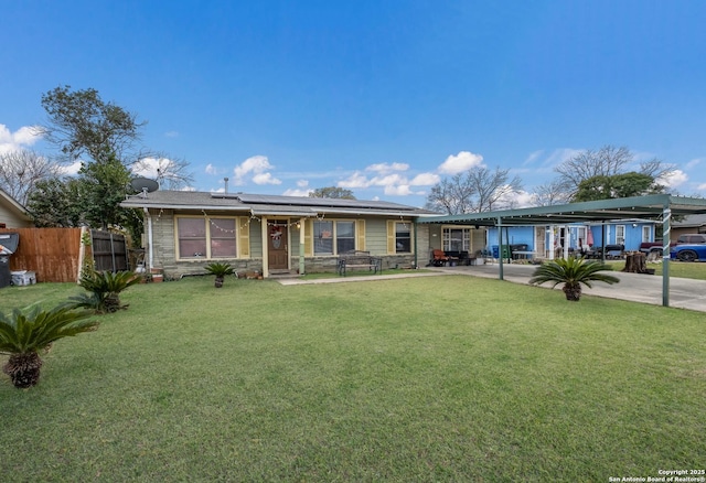 single story home featuring a front lawn and solar panels