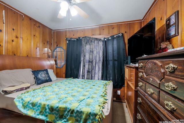 bedroom with ornamental molding, ceiling fan, and wood walls